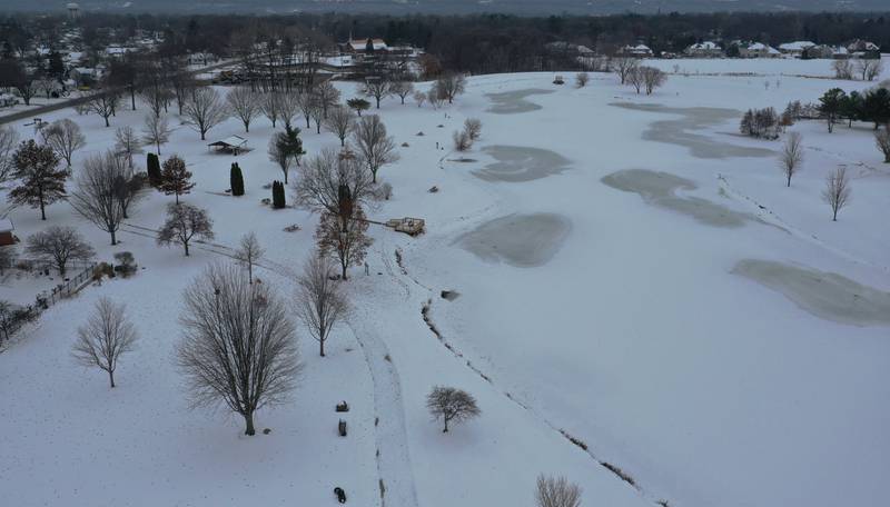 An aerial view of Baker Lake looking south on Tuesday, Dec. 9, 2025 in Peru. The concrete pathways have been poured but they will not be plowed this winter in order for the concrete to properly cure. Plowing the walkways to soon and applying salt could cause cracking and divots to the surface. Construction work began in early October and the park still remains closed to the public.