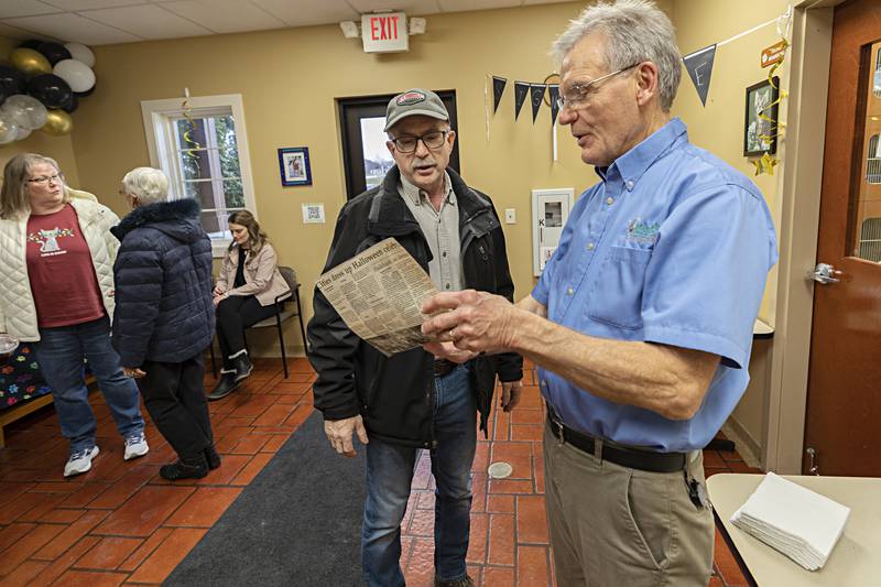 Rich Chapinski of Rock Falls presents Dr. Bill Kuhfus with a newspaper clipping from the early 90’s Thursday, Dec. 28, 2023 at the doctor’s going away party. “He always did what was needed, he took care of it,” said Chapinski about his long time veterinarian.
