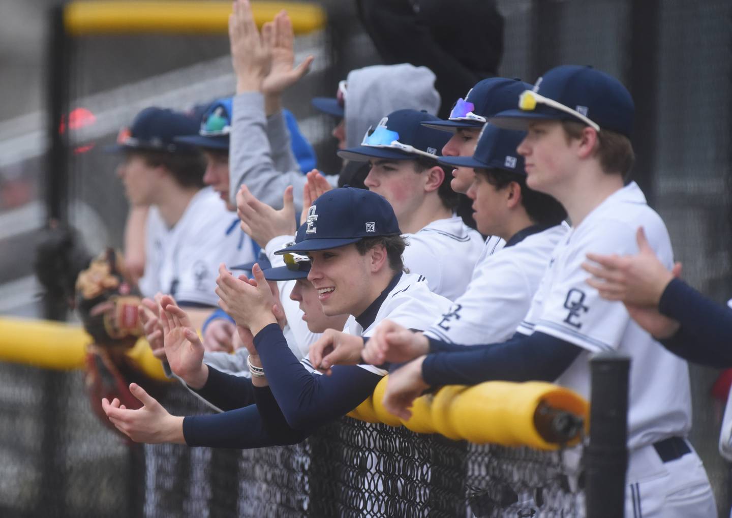 Oswego East players cheer on their batter during Wednesday's baseball game against Naperville North in Naperville.