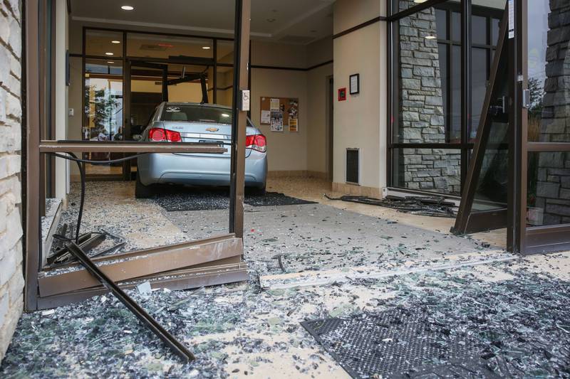A woman suffered minor injuries after crashing her vehicle into the First National Bank of Omaha in Woodstock Sunday night, Aug. 14, 2022.