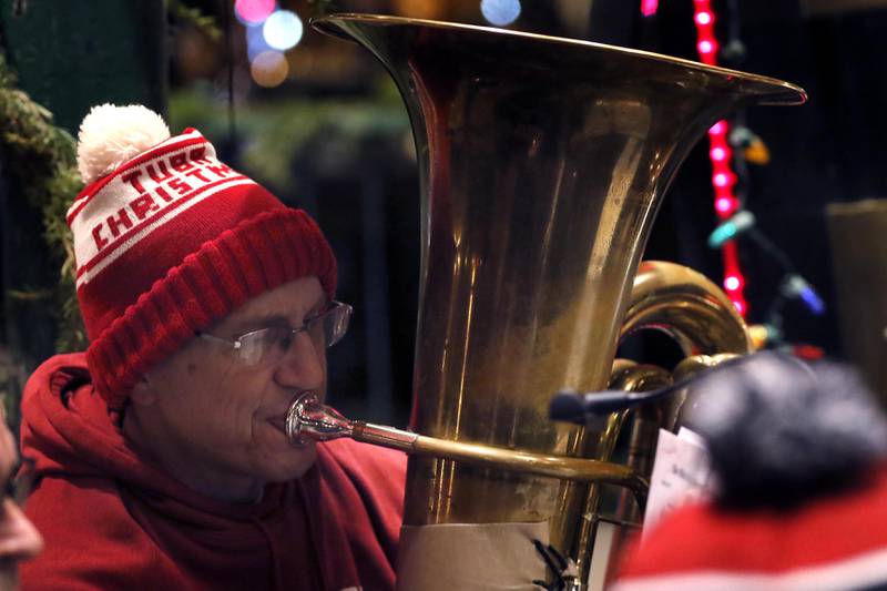 Brian Allen, plays the tuba with the Brass Act during the Lighting of the Square on Friday, Nov. 28, 2025, in Woodstock.The annual holiday season event featured brass music, caroling, free doughnuts and cider, food trucks, festive selfie stations and shopping.