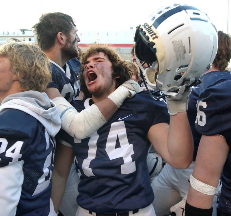 Cary-Grove's Michael Long celebrates with teammates Saturday, Nov. 25, 2023, after their win over East St. Louis in the IHSA Class 6A state championship game in Hancock Stadium at Illinois State University in Normal.