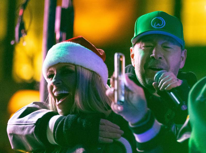 Donnie Wahlberg and Jenny McCarthy thanks St. Charles for its support while processing down Main Street in the Holiday Homecoming Electric Christmas Parade in St. Charles on Saturday, Nov. 30, 2024.