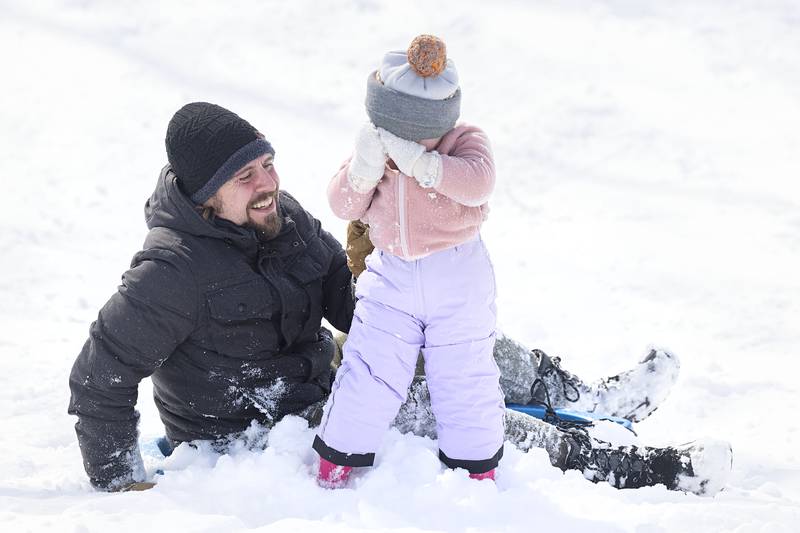 Cecily, 3, was unsure of the faceful of snow she and dad Nick DeLancey received while sledding Monday, March 16, 2026, at EC Smith Park in Dixon.