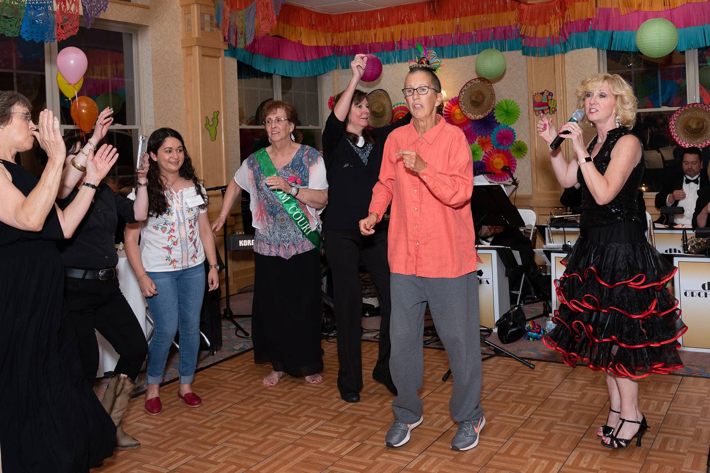 Timbers of Shorewood volunteer Joni Hilger encourages attendees to dance at The Timbers' annual senior prom in 2018.