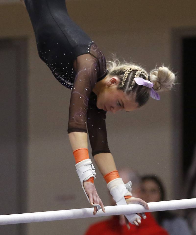 Warrenville South's Haylie Hinkley competes in the preliminary round of the uneven parallel bars Friday, Feb. 17, 2023, during the IHSA Girls State Final Gymnastics Meet at Palatine High School.