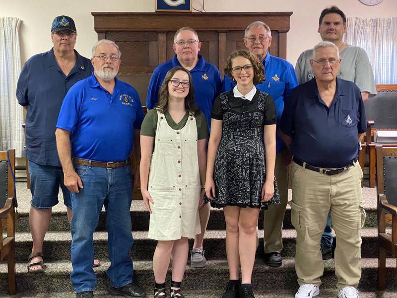 The Walnut Masonic Lodge presented $2,000 scholarships to Brooklynn Cade (front middle right) and Abigail Siri (front middle left). Each recipient received a check for $1,000 to help with school expenses and another $1,000 will be added to their school accounts.