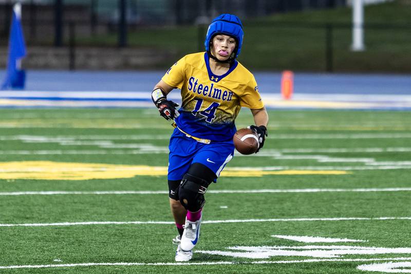 Joliet Central's Elliana Fowler picks up yardage during a varsity flag football game against Joliet West at Joliet Central on Oct. 2, 2025.