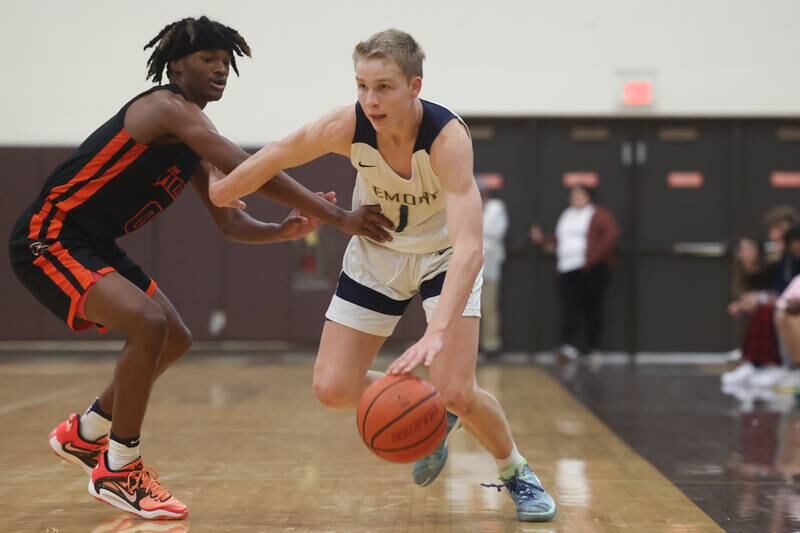 Lemont’s Matas Castillo drives around Romeoville ’s Adam Walker in the WJOL Thanksgiving Classic Championship in Joliet on Saturday.