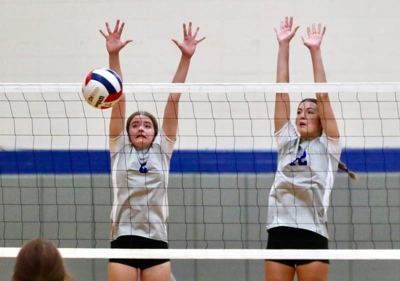 Princeton's Karsyn Brucker (left) and Chrissy Sierens put up a block against Hall Tuesday night at Prouty Gym. PHS won 25-11, 25-20.