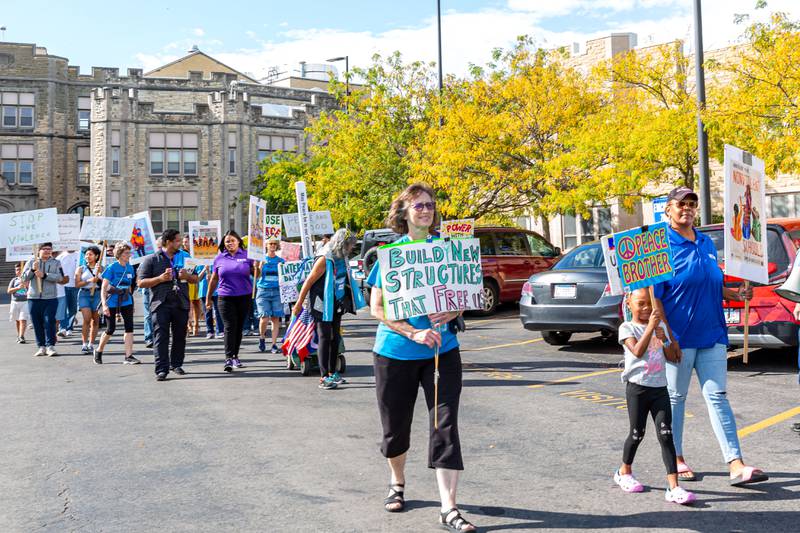 Attendees participate in a Peace Walk around the school at the Joliet Central High School Peace Walk. Sept 21, 2024 in Joliet.