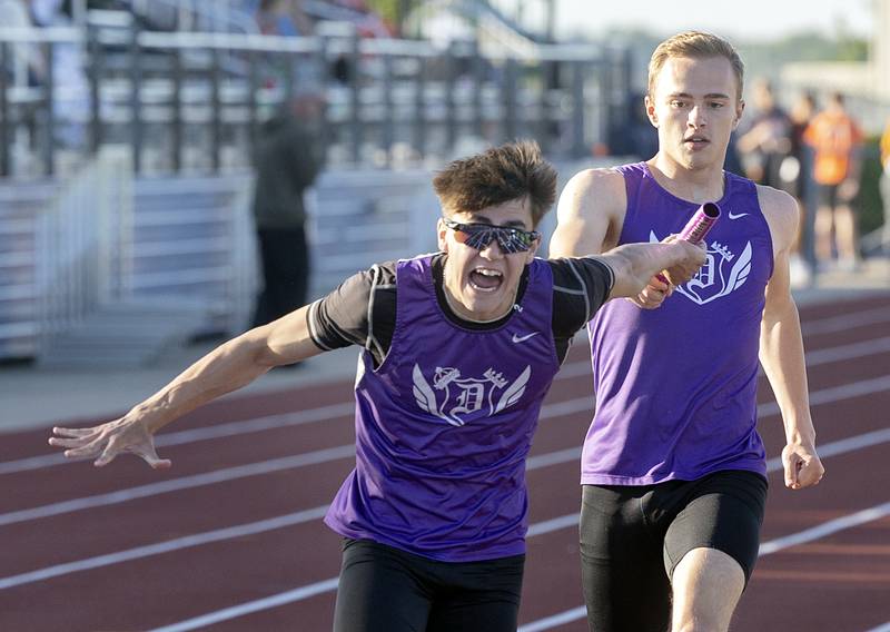 Dixon’s Jayden Toms hands the baton off to Noah Flynn in the 4x2 Wednesday, May 20, 2026, at the Rochelle Class 2A boys track sectionals.