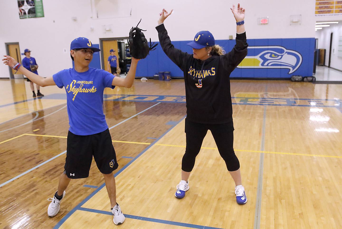 Johnsburg assistant baseball coach Sandy Landvick works with Leo Cahue on this throwing technique during an indoor baseball practice schedule Monday, May. 1, 2023, at the school.