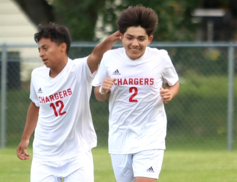 Dundee-Crown’s Gabriel Herrera, right, is greeted by teammate Diego Granados, left, after a Charger goal in boys soccer at Crystal Lake Central Tuesday evening.