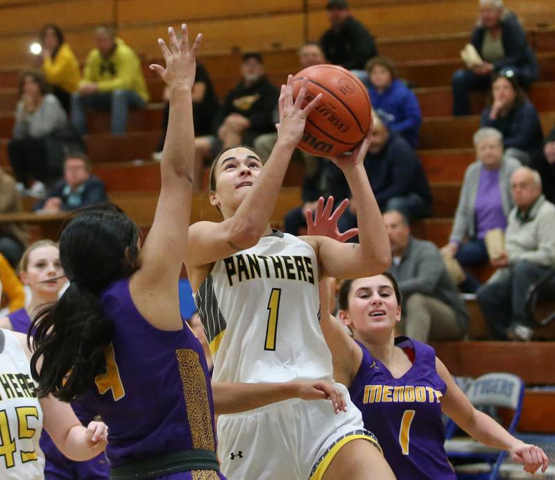 Putnam County's Ava Hatton runs in for a layup between Mendota defenders Crystal Garcia and Ava Eddy during the Princeton High School Lady Tigers Holiday Tournament on Tuesday, Nov. 14, 2023 in Prouty Gym.