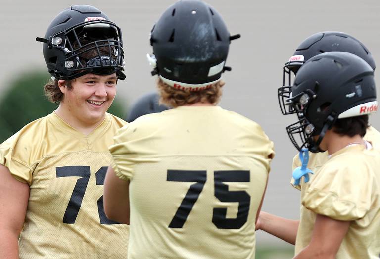 Sycamore's Lincoln Cooley (left) has a laugh with teammates during a break Monday, Aug. 8, 2022, at the school during their first practice ahead of the upcoming season.