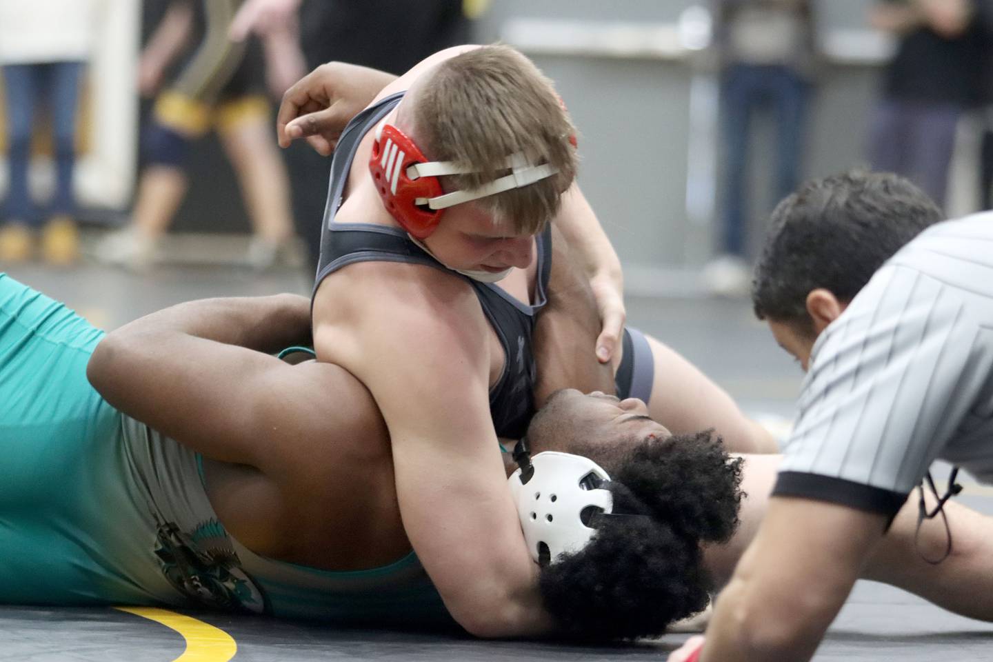 Marian’s Jimmy Mastny pins Woodstock North’s David Randecker at 215 pounds in boys wrestling IHSA Class 2A Regional championship bout action on Saturday, Jan. 31, 2026, at Harvard High School in Harvard.