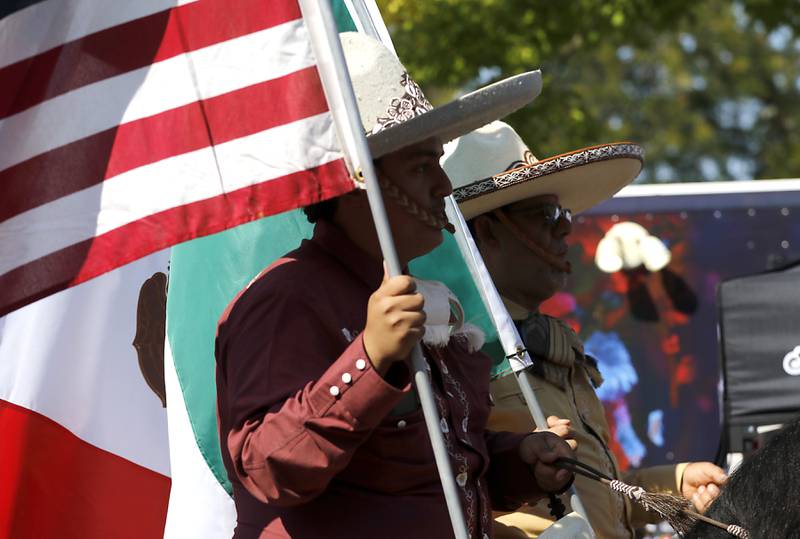 Riders carry the American and Mexican flags  on Sunday, Sept. 14, 2025, during the annual Hispanic Connections Mexican Independence Day Celebration in the Historic Woodstock Square. The celebration featured music, food and culture.
