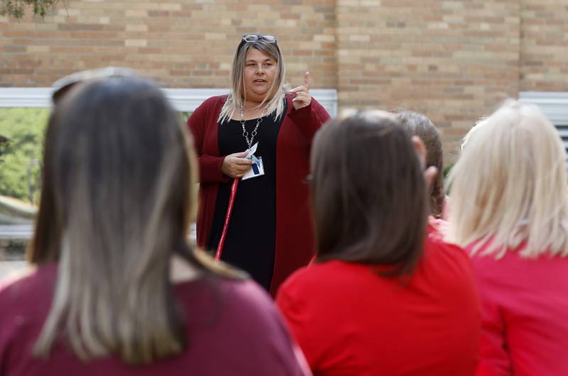 Union president Stephanie Lieurance talks to members of the Crystal Lake District 47 paraprofessional union as they meet outside Lundahl Middle School on Monday, Aug. 28, 2023, for an update on the union's complaint against District 47 for using a staffing agency to fill paraprofessional positions.