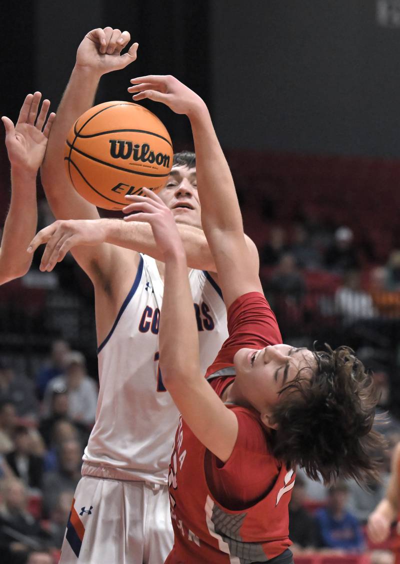 Eastland’s Zyacn Haverland blocks a shot by Aurora Christian’s Jacob Baumann in a IHSA Class 1A boys basketball supersectional at Northern Illinois University in DeKalb on Monday, Mar. 10, 2025.