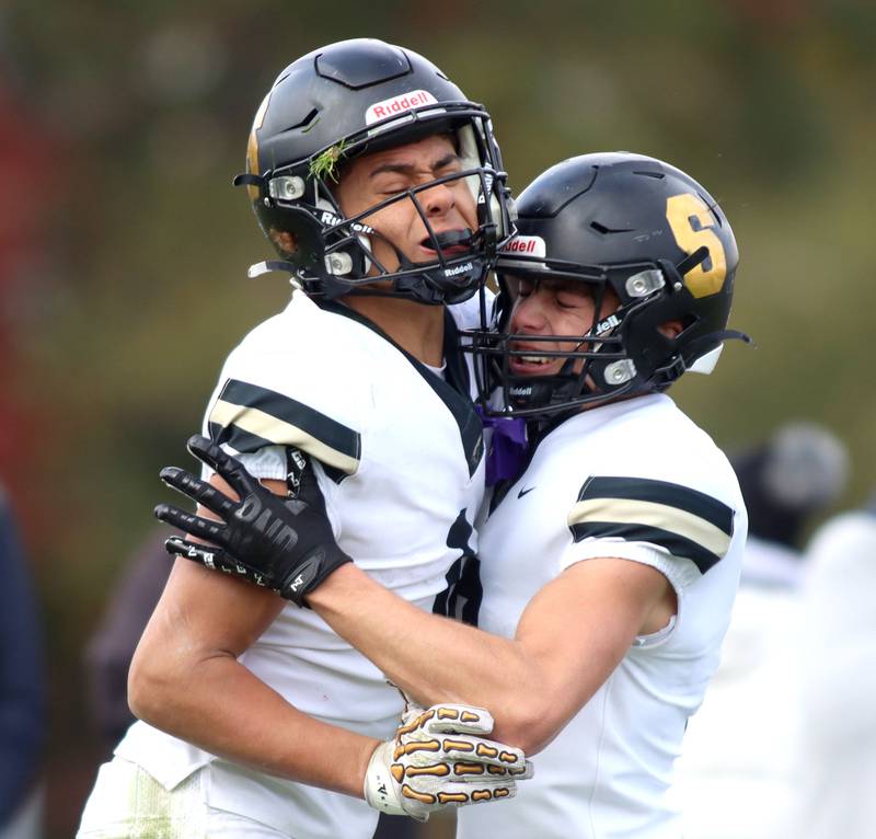 Sycamore’s Josiah Mitchell, left, is greeted by Benjamin Anderson after a Mitchell touchdown in IHSA football Class 5A first-round playoff action at Al Bohrer Field on the campus of Cary-Grove High School in Cary on Saturday, November 1, 2025.