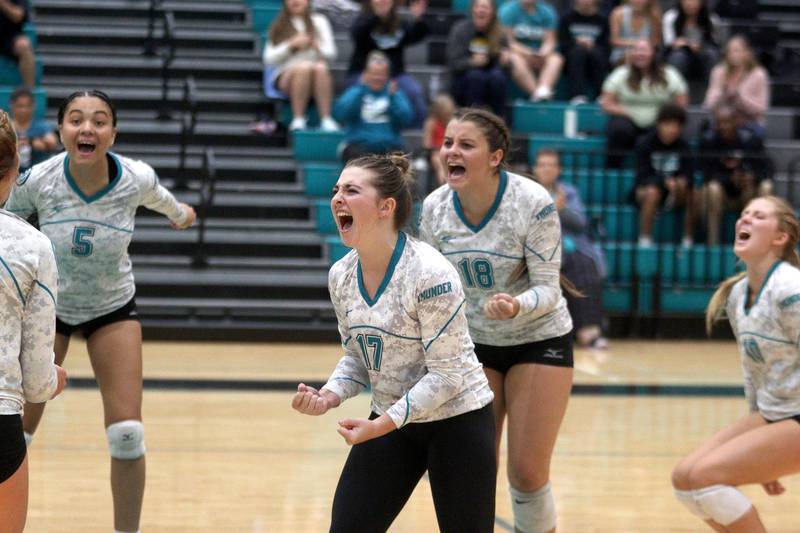 Woodstock North’s Thunder celebrate a point against Richmond-Burton in varsity volleyball at Woodstock Monday night.