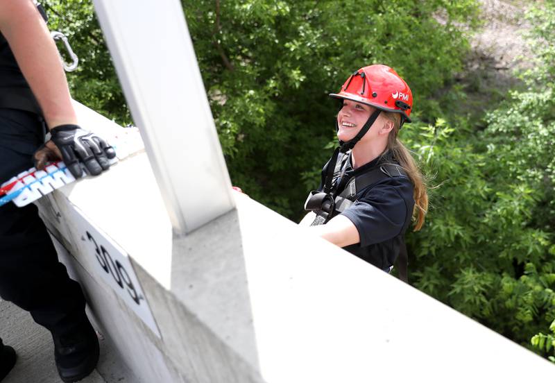 Geneva Fire Recruit Kelly Hunecke prepares to rappel down the side of the Third Street Commuter Parking Deck during a training exercise on Tuesday, May 13, 2025 in Geneva.