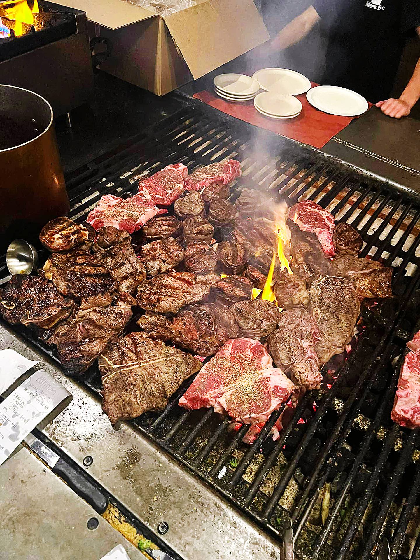 Steaks are prepared on a charcoal grill at Blackhawk Steak Pit in Oregon.