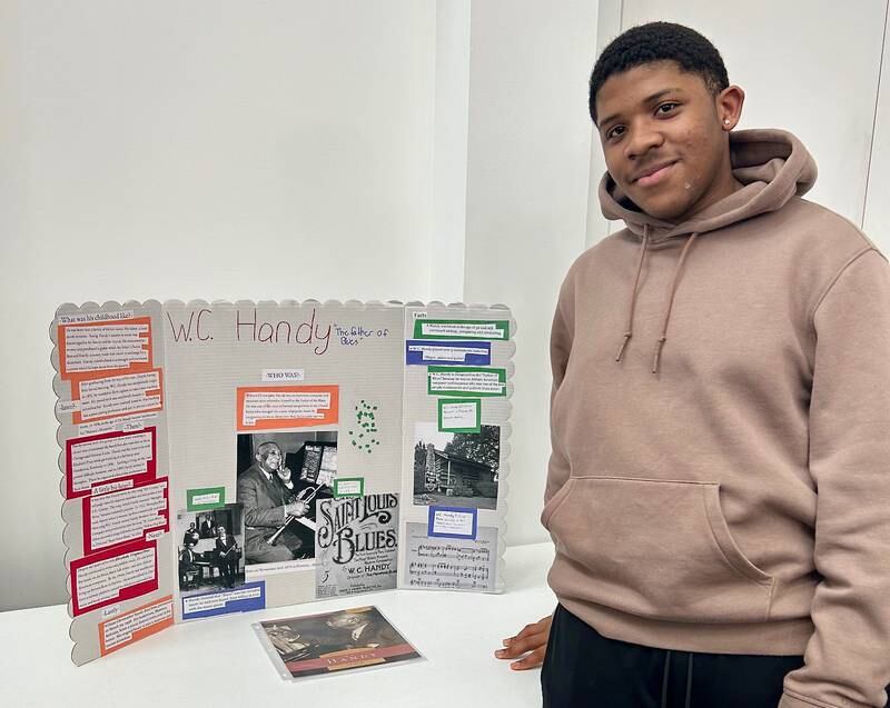 Jahkai Threadgill presents a poster board with his work on W.C. Handy, a Blues musician and artist, on Sunday, Feb. 16, 2025, at New Hope Missionary Baptist Church in DeKalb. Threadgill's presentation was part of the church's annual Black History Month event "Displays of Excellence."