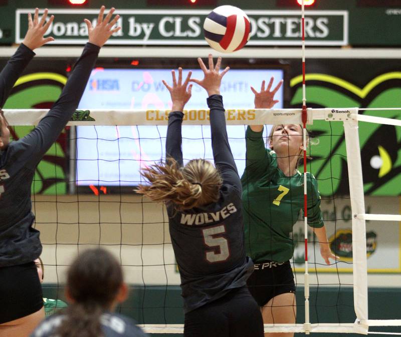 Crystal Lake South’s Gabby Wire (7) sends the ball past Prairie Ridge’s Grace Jansen (5) in varsity volleyball at Crystal Lake South Tuesday night.