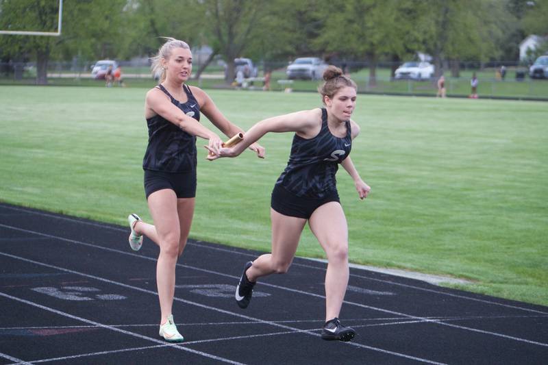 Sycamore's Olivia Kirby makes the exchange with Ashlyn Smid in the 4X200 Meter Relay at the Interstate 8 Girl's track meet on Friday, May,5,2023 in Sycamore.