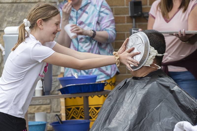 A fifth grader, whose name was withheld at the request of parents, at St. Anne School in Dixon, gives teacher Steve Caudillo a face full of pie Friday, May 5, 2023. The school held a jump rope-a-thon — and other physical activities — for the American Heart Association Kids Challenge. For meeting a fundraising goal, Caudillo agreed to be pied by a students.