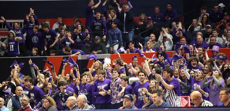 Downers Grove North superfans react after Jack Stanton hits a three point shot over Moline during the Class 4A state semifinal game on Friday, March 10, 2023 in Champaign.
