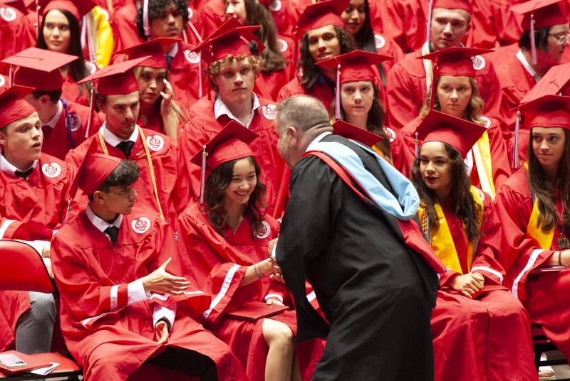 Principal David Travis, congratulates graduates after they received their diplomas during Yorkville High School's class of 2022 graduation ceremony at the NIU Convocation Center on Friday, May 20, 2022.