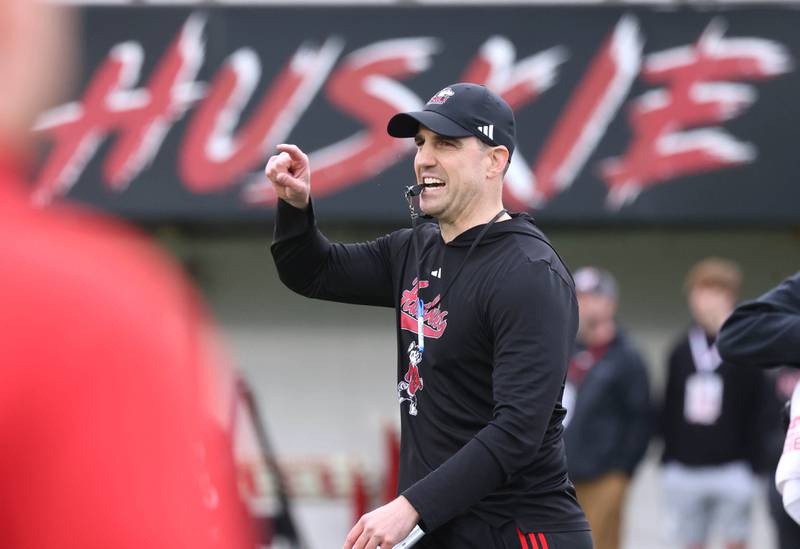 Northern Illinois University head football coach Rob Harley instructs his team Tuesday, April 14, 2026, during spring practice in Huskie Stadium at NIU in DeKalb.