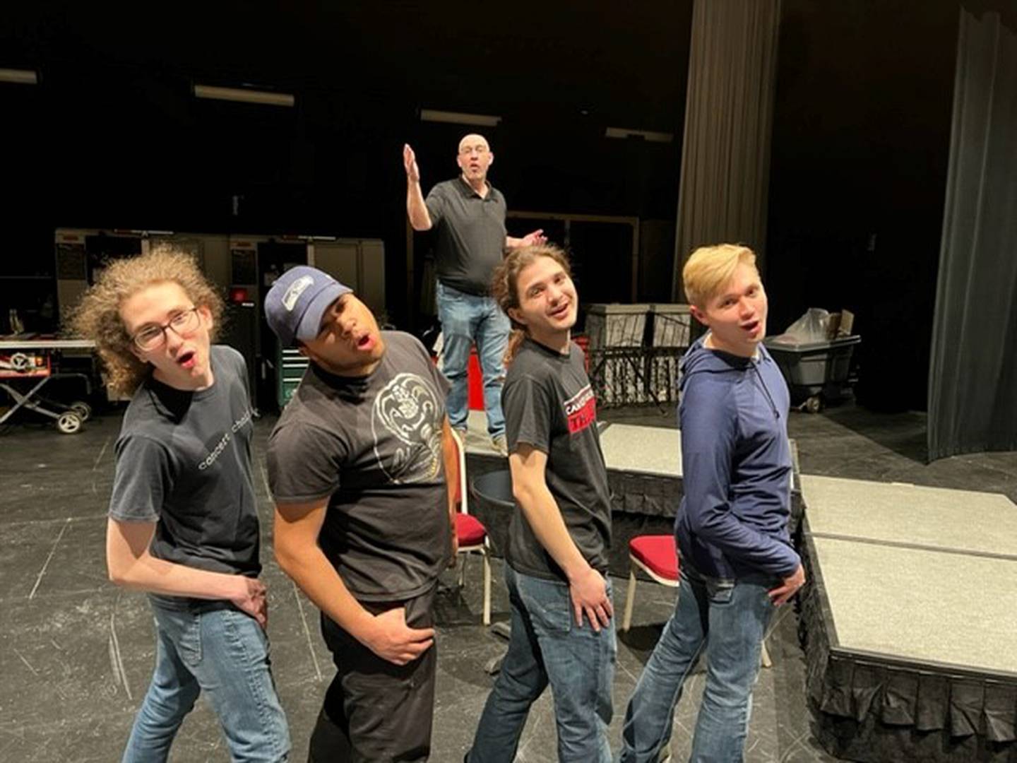 "Broadway Backwards" cast members Reid Rynke (left) Ethan Shaver, Bob Philip (on stage), David Zuniga and Ben Gensler rehearse Wednesday in the Dr. Mary Margaret Weeg Cultural Centre at Illinois Valley Community College.