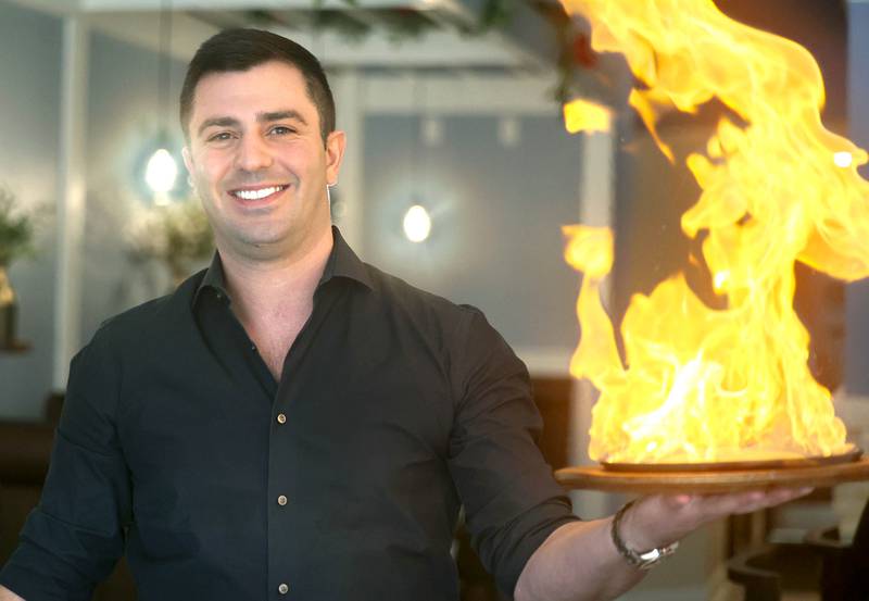 The Flame owner Foti Pappas lights some saganaki Friday, Jan. 19, 2024, in the eatery at 209 East Lincoln Highway in DeKalb. Sagainaki is cheese that is flamed tableside for the patrons.