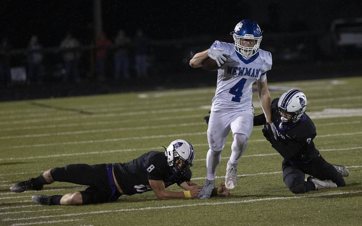 Newman’s Matthew Blackert gets by a pair of El Paso tacklers Saturday, Nov. 8, 2025.
