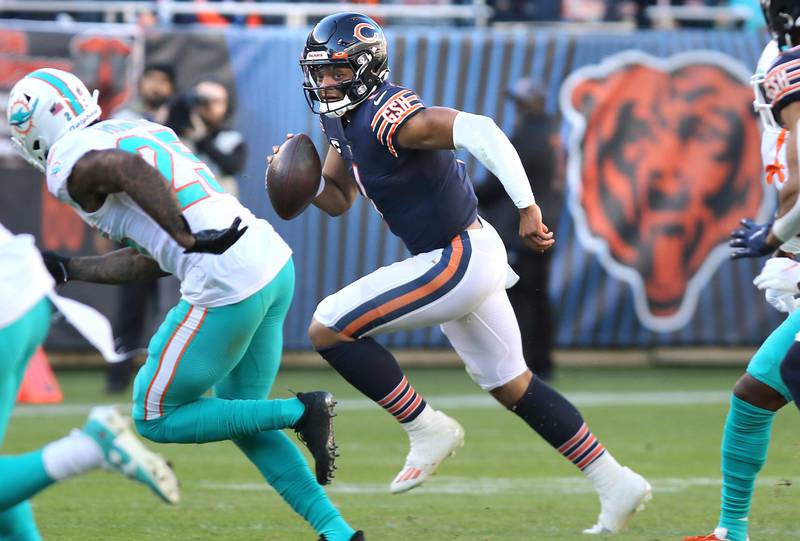 Chicago Bears quarterback Justin Fields scrambles away from the Miami pass rush during their game Sunday, Nov. 6, 2022, at Soldier Field in Chicago.