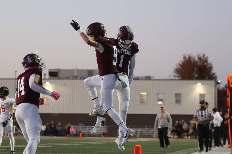 Lockport’s Adam Kozak (9) celebrates his touchdown with Izeyah Pruitt against Lincoln-Way West on Friday, Oct. 18, 2024 in Lockport.