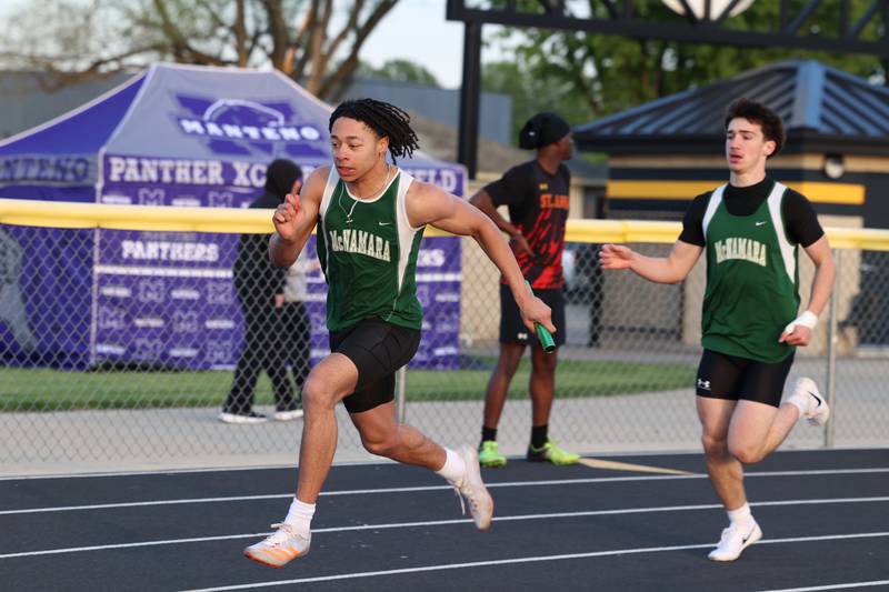 Bishop McNamara's Micah Lee accelerates after the handoff during the 4x200 relay race at the Herscher Track Invite on Friday, May 1, 2026.