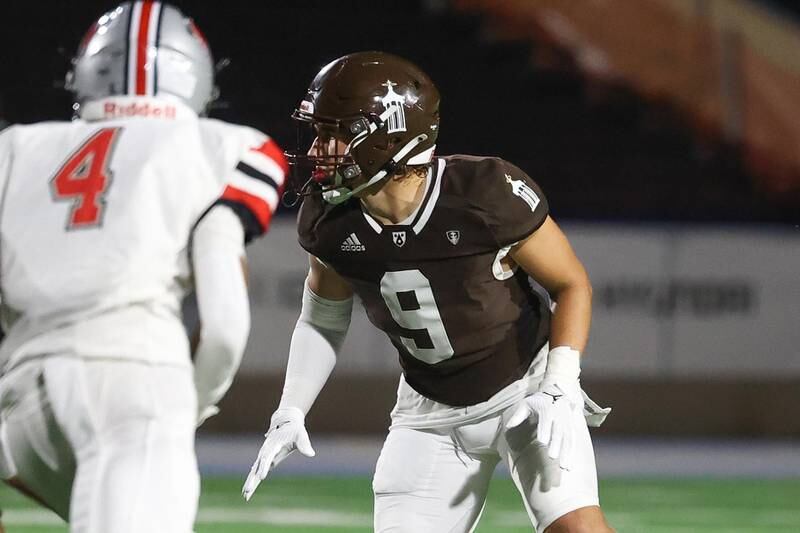 Joliet Catholic’s Zac Beitler eyes the Iowa City quarterback on Friday, August 30, 2024 in Joliet.