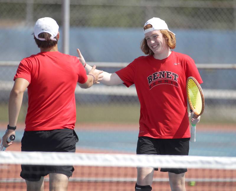 Doubles partners Zach Bobofchak (left) and Hugh Davis (right) high-five during the Class 1A Boys State Tennis Meet at Hoffman Estates High School on Thursday, May 25, 2023.