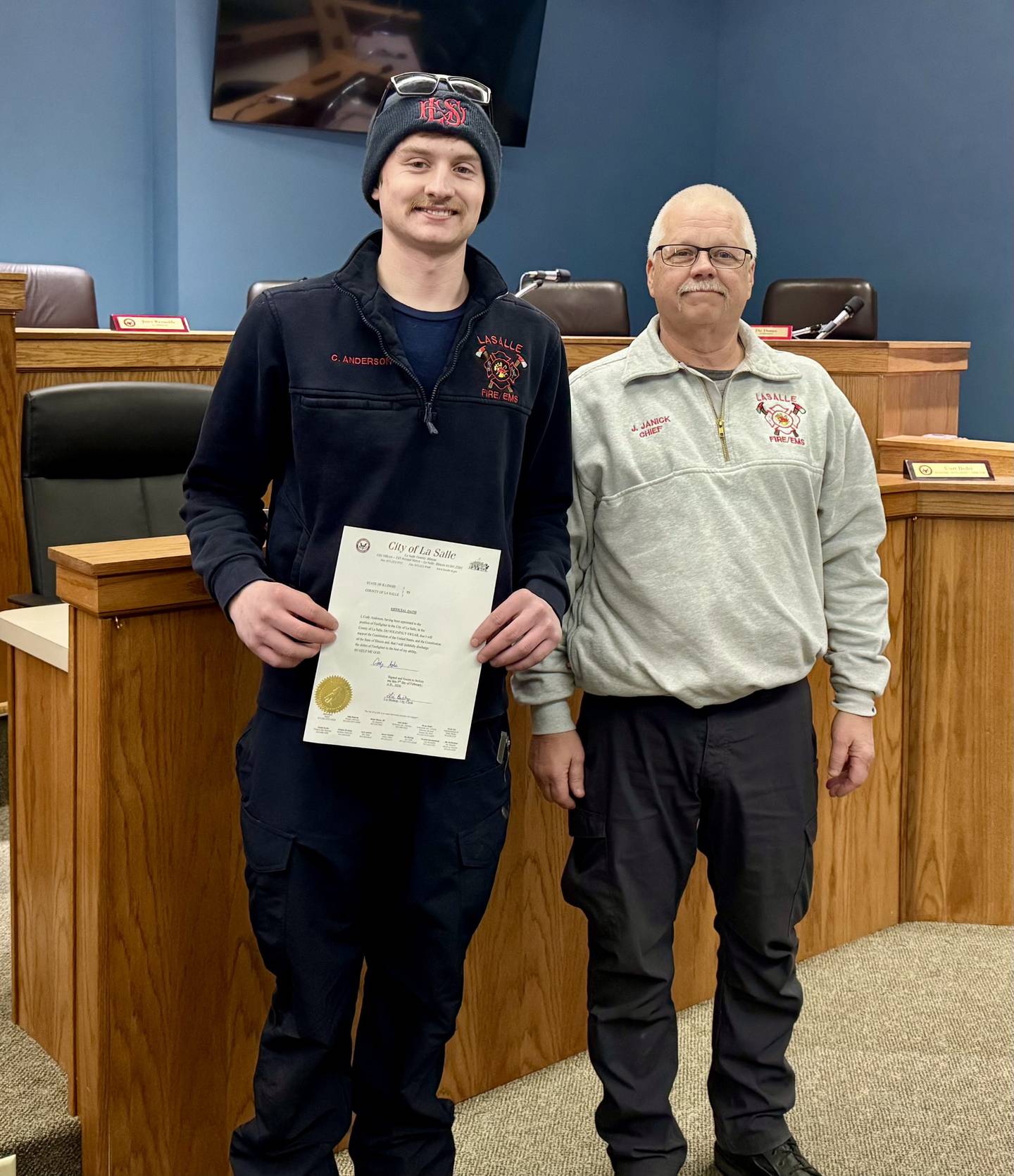 Cody Anderson stands with Fire Chief Jerry Janick after being sworn in as a firefighter and EMT for the La Salle Fire Department.