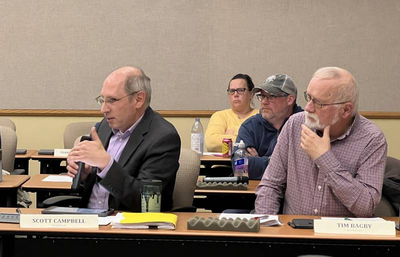 DeKalb County Board member Scott Campbell, a Democrat from District 7, talks during the May 21, 2025 DeKalb County Board meeting while Republicans Elizabeth Lundeen, from District 4, Bejamin Haier, from District 5, and the head of the DeKalb County Republicans Tim Bagby, from District 3 listen.