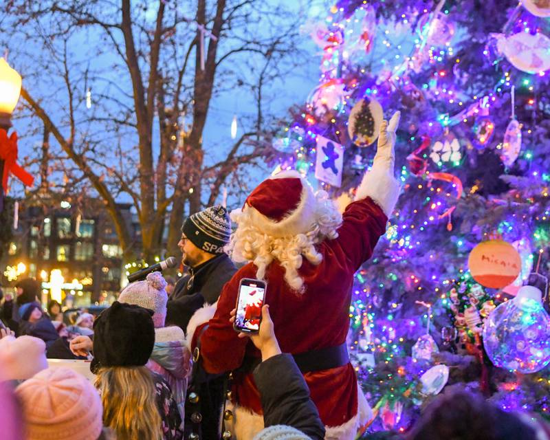 Santa Clause helps Downers grove Mayor Pro Tem Greg Hose and community members on Friday Nov. 29, 2024, light the tree during the tree lighting ceremony in downtown Downers Grove.