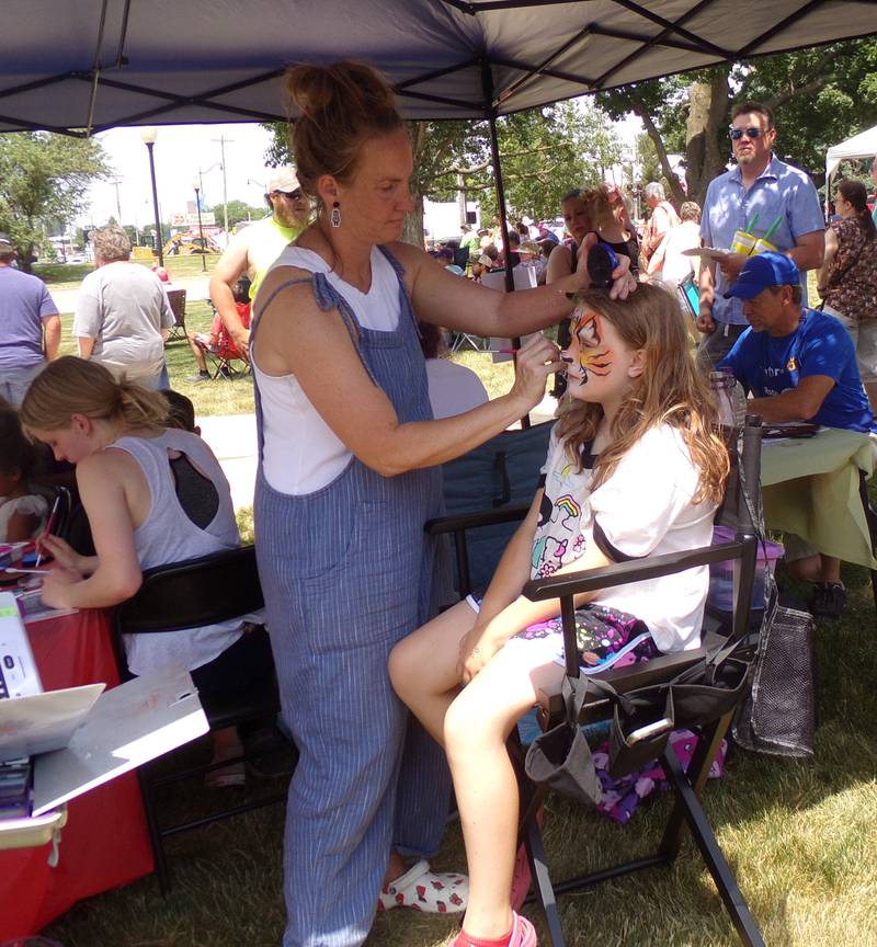 Odett Johnson, of Princeton, gets her face painted Saturday, June 3, 2023, during the Shrimp and Brew Hullabaloo at Rotary Park in Princeton.