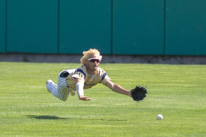Ottawa-Marquette’s Julian Alexander dives but comes up short for the catch against Brown County Friday, June 3, 2022 during the IHSA Class 1A baseball state semifinal.