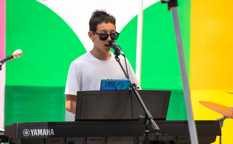 Double Helix keyboardist Lucas Turner sings during Make Music Wheaton and the Wheaton French Market in The Wheaton French Market Plaza on Saturday, June 21, 2025.