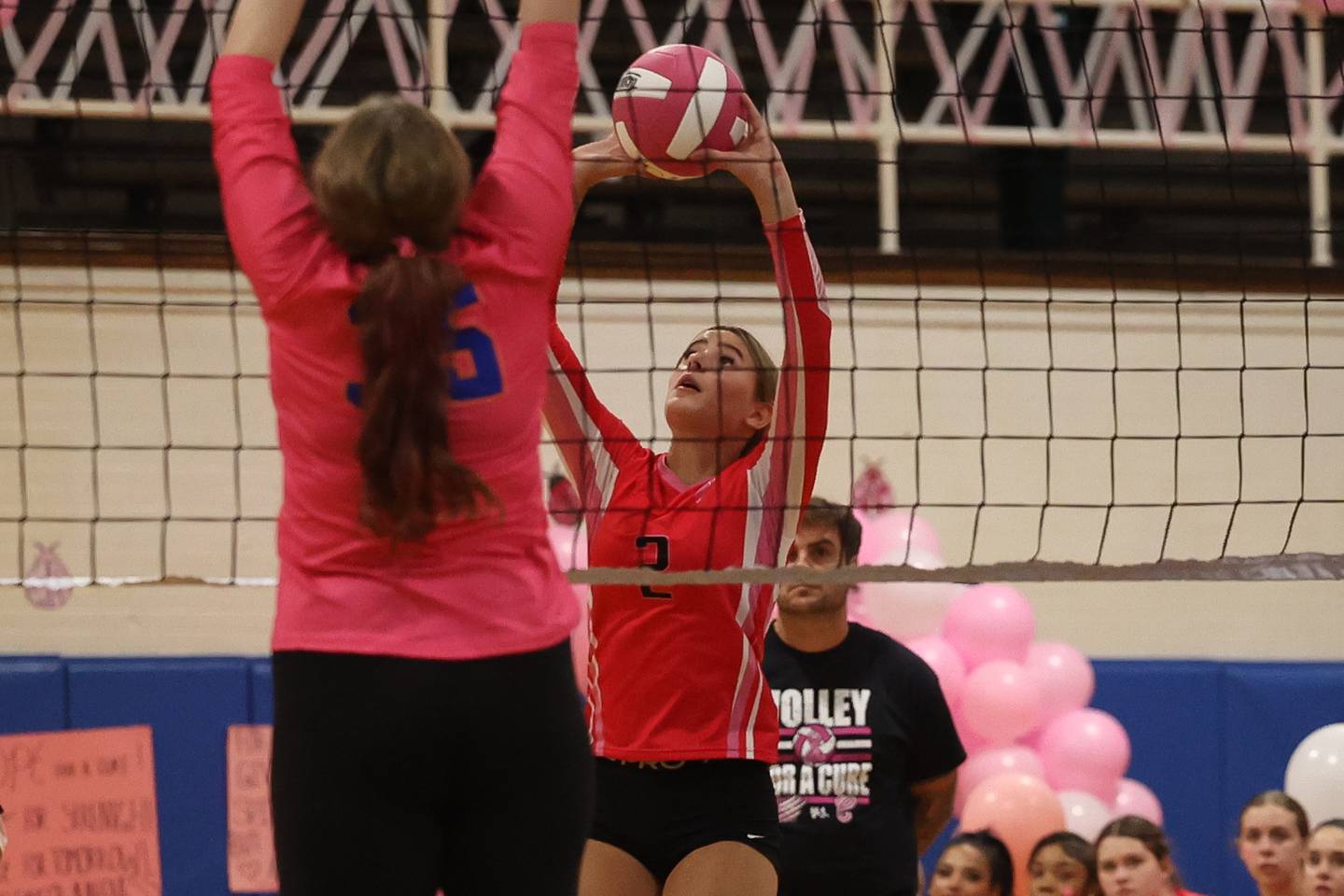Joliet West’s Lexie Gevengoed pushes over a shot against Joliet Central in the annual Pink Heals cancer fundraising match on Thursday, Oct. 17, 2024 in Joliet.